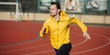 © antgor - Sportsman running on a stadium, sprinter man on red tracks lanes in high speed