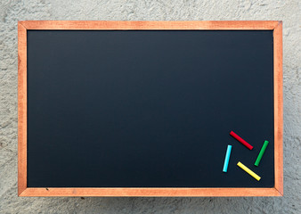 Wall Mural - Empty chalkboard texture with colorful chalks, hang on the cement wall. double frame from blackboard and cement wall. image for background, wallpaper and copyspace. bill board wood frame for add text.