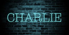 First Name Charlie In Blue Neon On Brick Wall