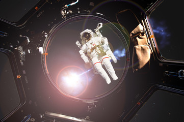 Wall Mural - view through the space ship illuminator of astronaut in open spacce with flare frome the star (image