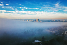 Foggy Morning In Toronto City, Canada. Rays Of Early Rising Sun.  Landscape Aerial Top View With Urban Street Covered With Thick Fog. Day White Transparent Mist In Canadian Metropolia At Sunrise.