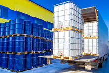 Discharge Of Plastic Barrels. Barrels For The Chemical Industry. Blue Metal Barrels. White Plastic Containers. Chemical Industry. The Machine Brought Chemical Substances.