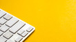 keyboard close up on yellow background