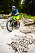 © Gorilla - Tourist cycling in Cortina d'Ampezzo, stunning rocky mountains on the background. Man riding MTB enduro flow trail. South Tyrol province of Italy, Dolomites.