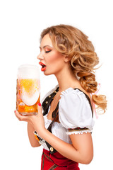 Wall Mural - Oktoberfest / Creative concept photo of Oktoberfest waitress wearing a traditional Bavarian costume with beer isolated on white background.