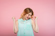 © golubovy - emotion expression. very happy joyful thrilled to bits woman with beaming smile and hands in the air. young beautiful blond girl portrait on pink background.