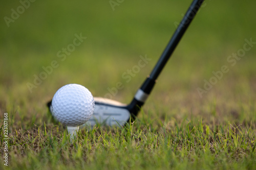Fotografia, Obraz Three metal wood at rest behind teed-up golf ball providing copy space for text or graphics
