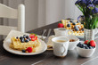Belgian waffle decorated  with strawberries,  blueberries and almond on wooden table for perfect  breakfast at Sunday. Homemade dessert background. Relax moments concept and lifestyle image
