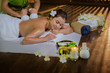 Young Asia beautiful woman during massage with spa herbal compress with oil and herbal set near site, relaxing and healthy concept.
