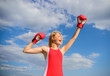 © be free - Girls power concept. Woman strong boxing gloves raise hands blue sky background. Girl boxing gloves symbol struggle for female rights and liberties. Feminism promotion. Fight for female rights