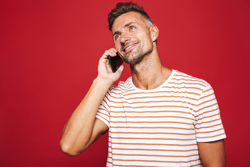 Poster - Portrait of a smiling man standing over red background