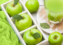 Glass Of Fresh Organic Apple Juice With Granny Smith Green Apples In Box On Wooden Background