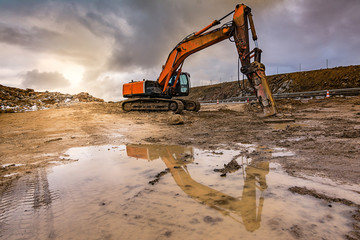 Wall Mural - Works in the construction of a road extracting stone in a hard day of winter work