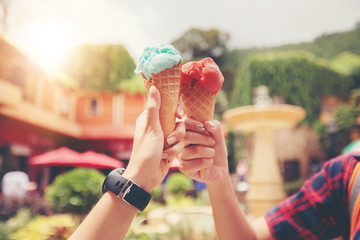 Beautiful female holding and eating ice cream on summer holidays