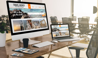 Wall Mural - computer, laptop, tablet, and phone with responsive travel website  at office mockup