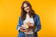 © Drobot Dean - Young woman posing isolated over yellow background reading book take notes.