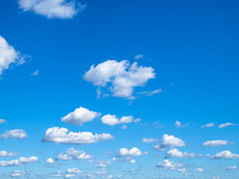 Many Little Puffy Clouds In Blue Sky In Sunny Day