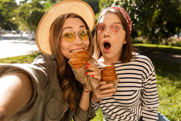 Poster - Two happy young girls friends having fun at the park