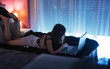 © ADDICTIVE STOCK - Teenage girl in sleepwear looking at her laptop in her room