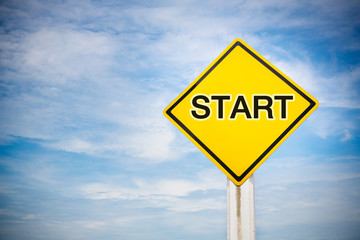 Start  text on traffic sign on yellow background with cloudy blue sky. symbol for transportation regulations. image for background, wallpaper and backdrop.