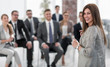 © ASDF - young business woman standing in conference room
