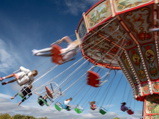 The motion of people on a fairground ride on a summer's day