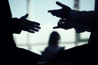 The business people work in the office. Hands silhouette. Making gestures while speaking.