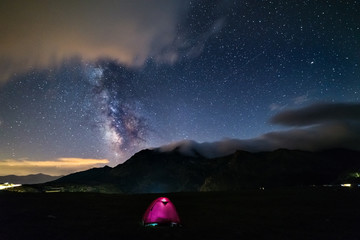 Wall Mural - milky way galaxy stars over the alps, camping illuminated tent, mars and jupiter planet, snowcapped 