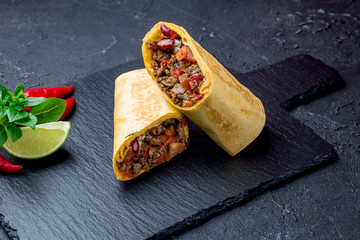 Wall Mural - Mexican burrito with meat on black