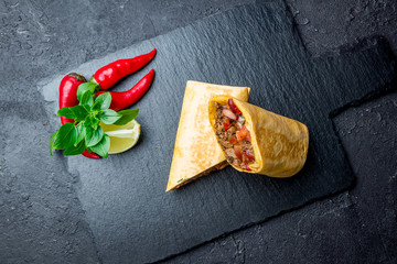 Wall Mural - Mexican burrito with meat on black