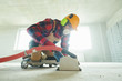 © Kadmy - builder at work. cutting concrete floor for cabling by diamond slitting machine