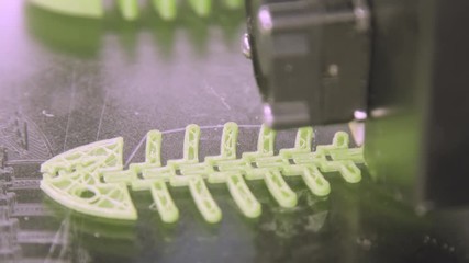 Wall Mural - Close Up of 3D printer while printing fish form. Plastic skeleton of fish lies on a white background. It is printed on a 3d printer. A very beautifully made thing. 3D printing in progress. Commercial
