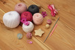 crochet pink white grey hooks and yarn, wooden background copy space