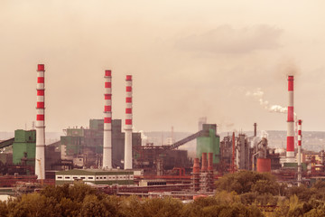 Wall Mural - Coal processing plant operates on the river bank. Smoke from the pipes pollutes the atmosphere of the city. Concept of pollution of the environment, emissions into water resources. Industrial landscap