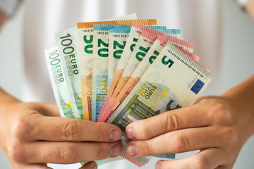 Man hands holding euro banknotes. Soft focus