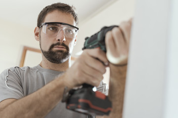 Wall Mural - Professional repairman using a drill