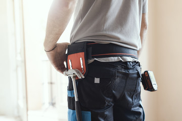 Wall Mural - Professional repairman standing and holding a drill