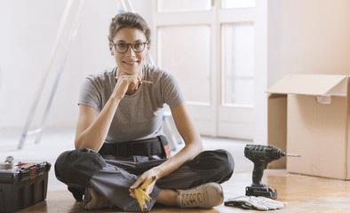 Wall Mural - Young woman moving in her new house and doing a home makeover