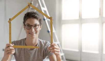 Wall Mural - Woman making a house shape with a folding ruler