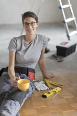 Wall Mural - Woman doing a home renovation and having a coffee break