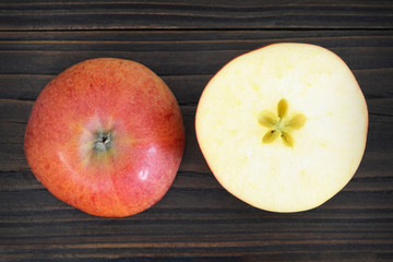 Wall Mural - Apple halves on wooden background