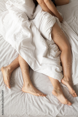 Close Up Of Romantic Couple Lying In Bed Hugging After Having Sex Man Embrace Girlfriend After