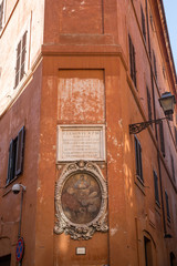 Wall Mural - Sculpture on and painting on a street corner in Rome, Italy