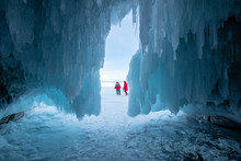 Two Women Outside An Icicle Covered Cave, Irkutsk Oblast, Siberia, Russia
