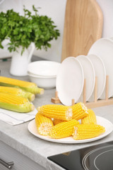 Sticker - Plate with ripe corn cobs on kitchen table