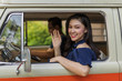 © geargodz - happy woman vintage window of old car and raising her hand