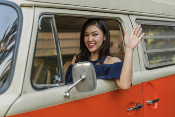 Canvas Print - happy woman vintage window of old car and raising her hand