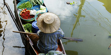 Woman Trading Fruit And Food In Boats At Damnoen Saduak Floating Market ,Thailand