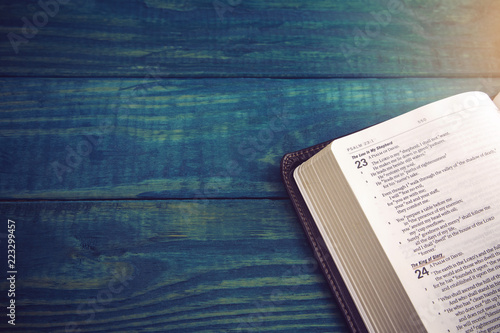 Fotomural Holy Bible on a Blue Wooden Table Out for Studying