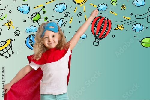 фотография Cute Child in superhero costume on background